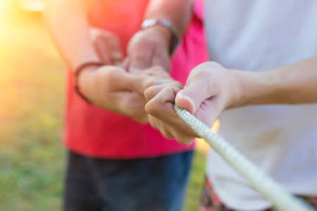 group of hands pulling ropeの写真素材