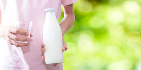 young man with bottle of milk and glass, fresh milkの写真素材