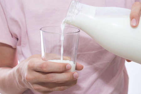 young man with bottle of milk and glass, fresh milkの写真素材