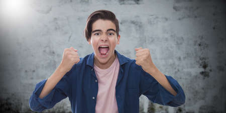 young man with an expression of success and euphoria on the backgroundの写真素材