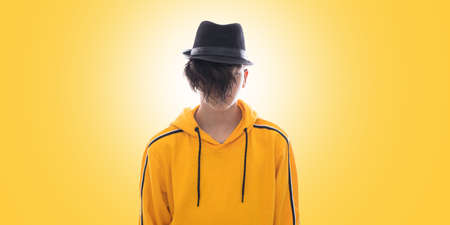 young fashioned teenager isolated in yellow backgroundの写真素材