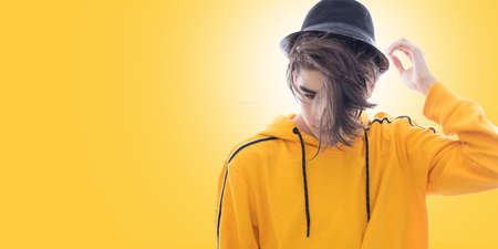 young fashioned teenager isolated in yellow backgroundの写真素材
