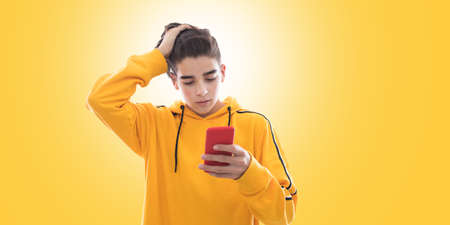 young teenager with mobile phone and isolated expressionの写真素材