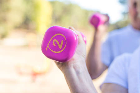 senior hand dumbbell doing gymnastics, active ageingの写真素材