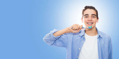 young with braces with toothbrushの写真素材