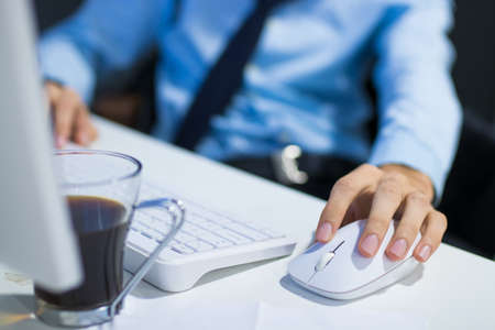 hands with the computer mouse in the officeの写真素材