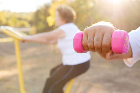 hand with gym weights and woman doing sportの写真素材