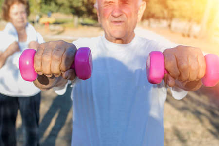 older people doing sports with outdoor weightsの写真素材