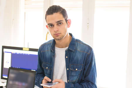 young fashion portrait with mobile phone and computer