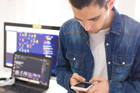 young fashion portrait with mobile phone and computer