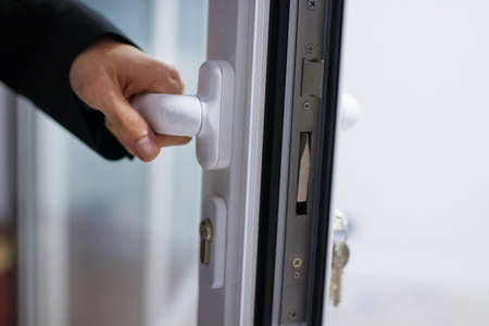 hand at the entrance door or access, lock and security
