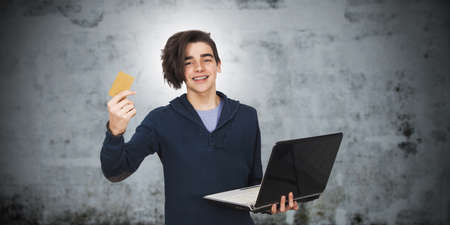 young with laptop and credit cardの写真素材