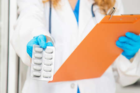 doctor with pills or medicines and folder of documents