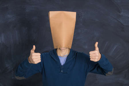 young man with shopping bag and expression of okay and satisfaction