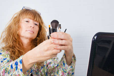 girl with makeup tools in handの写真素材
