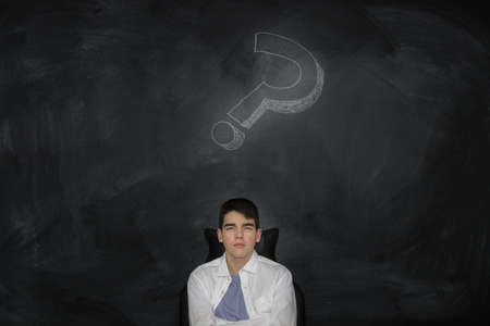 thoughtful young man with question markの写真素材