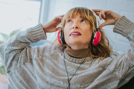 adult woman listening to music with headphones