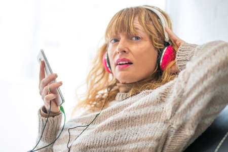 woman with mobile phone and earphones