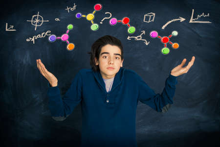young person with expression of problems and signs of scienceの写真素材