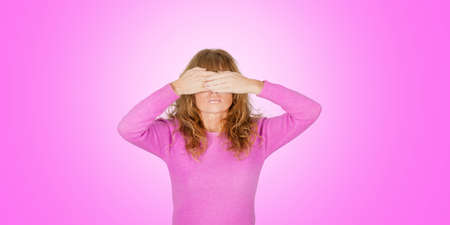 woman covering her eyes with hands on bottomの写真素材