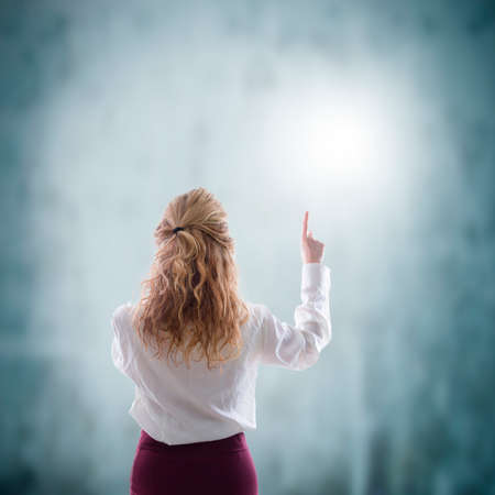 business woman pointing with abstract backgroundの写真素材