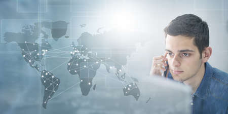 business man working with computer, phone and international connectionsの写真素材