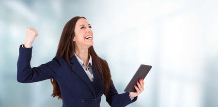 woman smiling with laptop, success and triumphの写真素材