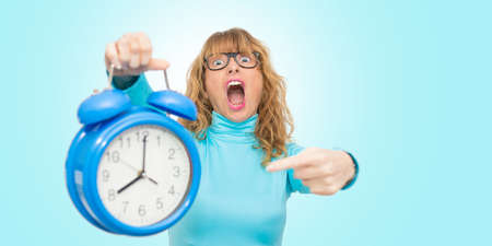 isolated woman with clock or alarmの写真素材