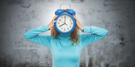 isolated woman with clock or alarmの写真素材