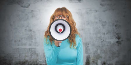 portrait of adult woman with megaphoneの写真素材