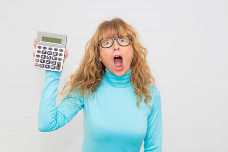 isolated woman with calculator astonished with surpriseの写真素材