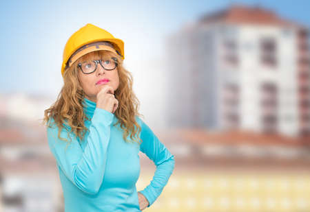 woman with construction helmet thinking