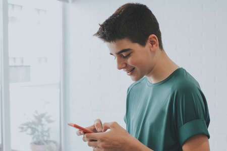 young or teen at home with mobile phone