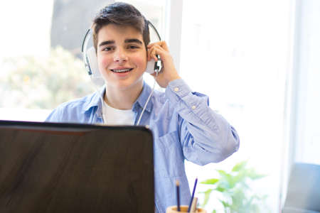 teenage student with computer laptop and headphonesの写真素材