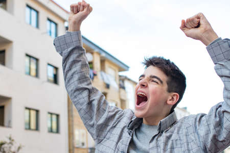 teen or student screaming and celebrating outdoors