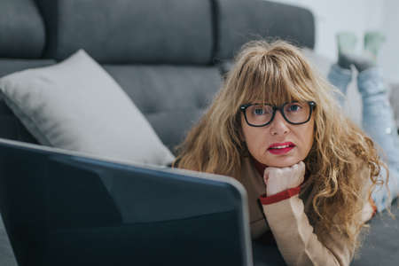 adult woman on the sofa with laptop