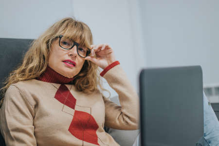 woman with laptop on the couchの写真素材