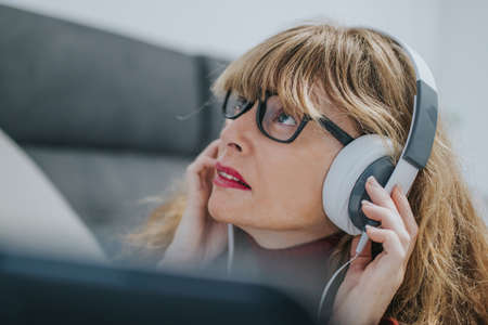 adult woman with headphones and laptopの写真素材