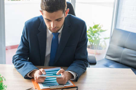 business man with mobile phone in office