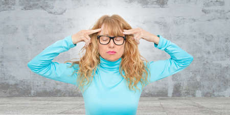 portrait of a woman with a headache or concentrated
