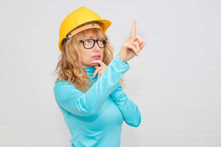 woman with construction helmet pointing, construction and architecture