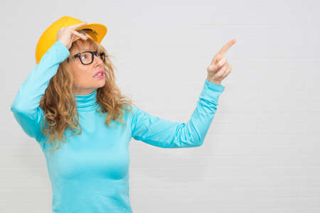 woman with construction helmet pointing, construction and architecture