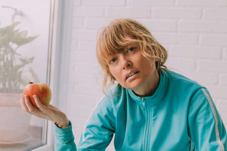 woman athlete with apple, diet and sport