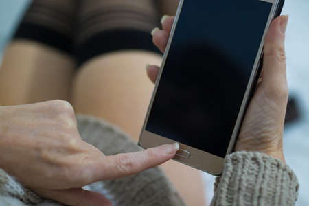 sexy woman with mobile phoneの写真素材