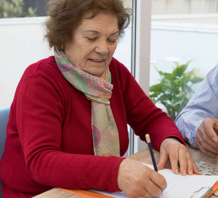 older adult woman writingの写真素材