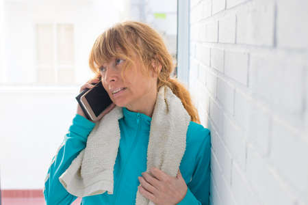 woman with sportswear and mobile phone