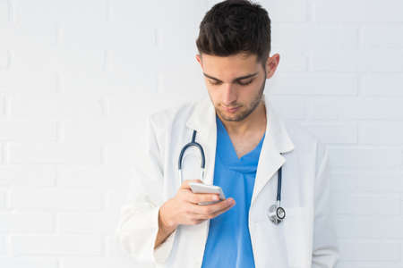 doctor with mobile phone and stethoscopeの写真素材