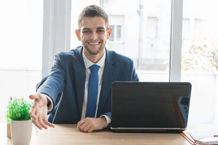 businessman in the office waving