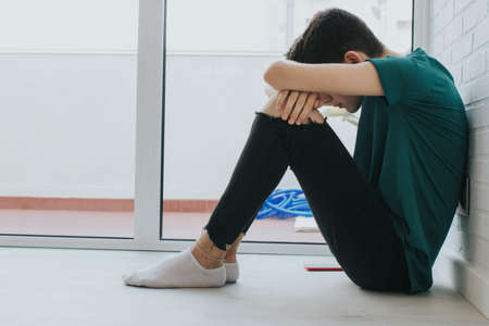 teenager sitting in solitudeの写真素材