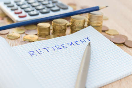 currencies and calculator with the concept of retirementの写真素材